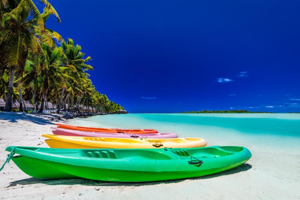 Aitutaki Lagoon Private Island Resort - Canoes on the beach