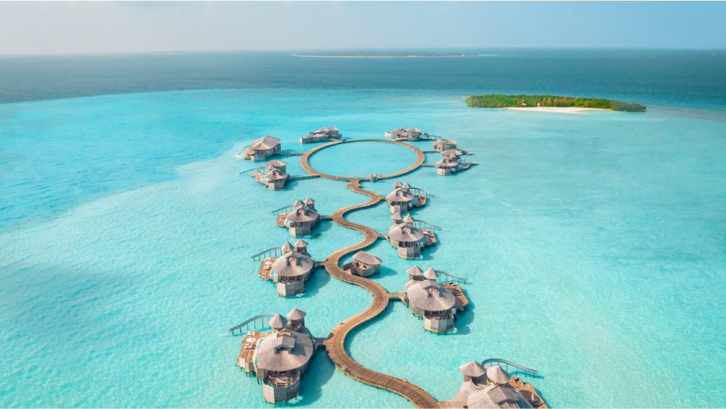 Maldives Luxury overwater bungalows with private infinity pools at sunset, reviewed by WaterBungalows.net.