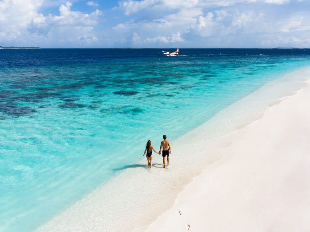 reethi faru resort couple beach