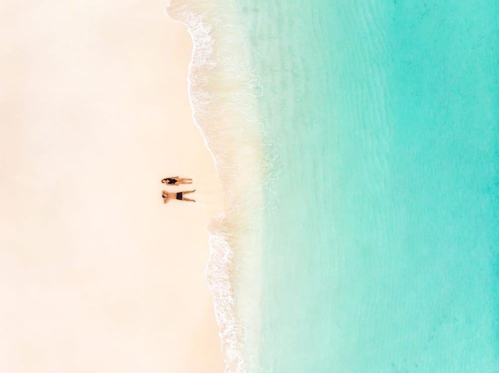 reethi faru resort couple on the beach